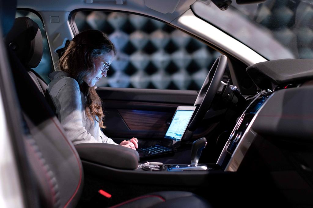 Network engineer analyzing diagnostic data on multiple monitoring screens